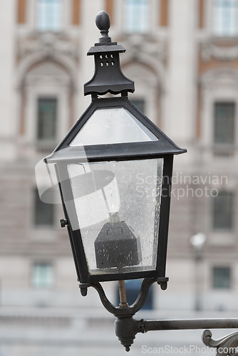 Image of Outdoor, lamp and street in city, vintage and retro for urban Cape Town to illuminate objects or areas. Winter, antique and light post for security in dark or night, alert and bulb in garden or park