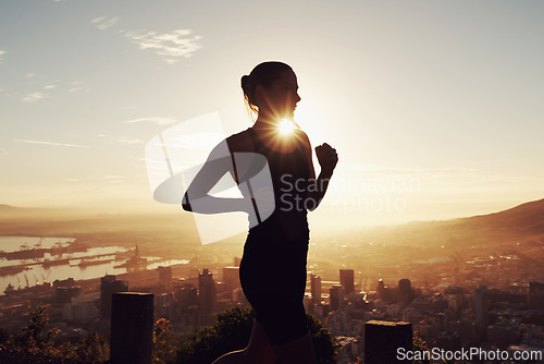 Image of Fitness, running and woman in silhouette on mountain for health, wellness and strong body development. Workout, exercise and girl runner on sunset path in nature for training, performance and city