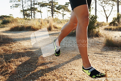 Image of Legs, running and person in park for fitness, cardio and health outdoor for training and wellness. Athlete, speed and action with runner on dirt path for race, workout and exercise with endurance