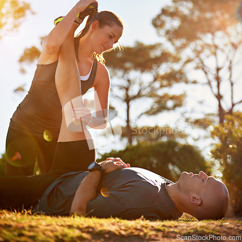 Image of Nature, help and couple stretching for fitness, workout coach and physio for healthy body. Exercise, wellness and woman with man in muscle warm up for outdoor training in morning on forest ground.