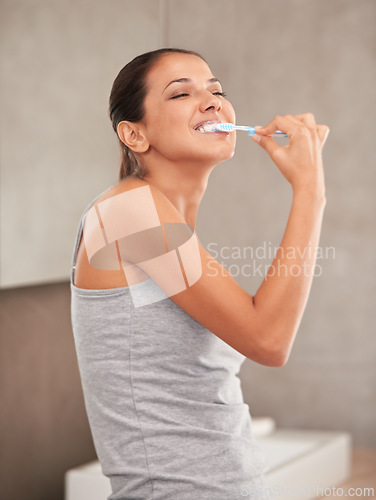 Image of Happy, bathroom and woman with toothbrush for cleaning, oral hygiene and dental care in home. Toothpaste, healthcare and person brushing teeth for whitening, wellness and grooming for gum disease