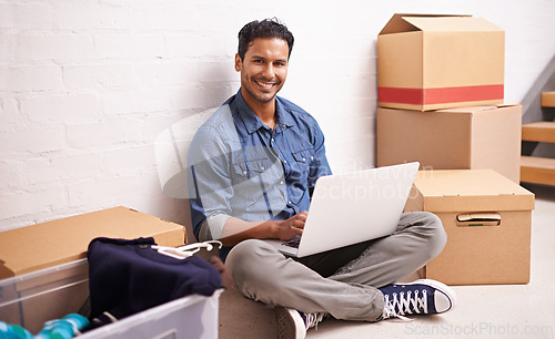 Image of Portrait, man and laptop by boxes in new house, apartment or property for moving, relocating or buying a home. Male person, real estate and mortgage for homeowner with computer, communication or tech