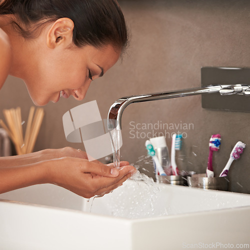 Image of Face, washing and woman with water in bathroom for skincare, beauty and wellness in morning routine. Health, dermatology and happy person with liquid splash for cleaning, hygiene and grooming at home