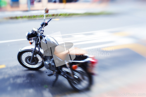 Image of Blur, parked motorbike in street and transportation for travel in city, journey or road trip for speed and adventure. Motorcycle, ride and commute with stationary bike outdoor, power and moto machine