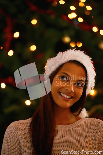 Image of Happy woman, home and idea for gifts by christmas tree, love and giving in holiday season for care. Young person, smile and excited or inspiration for present and celebration with kindness in house