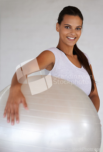 Image of Happy woman, portrait and training with exercise ball for workout, health and wellness at home. Young female person or yogi with smile for pilates, warm up or fitness in confidence with gym equipment