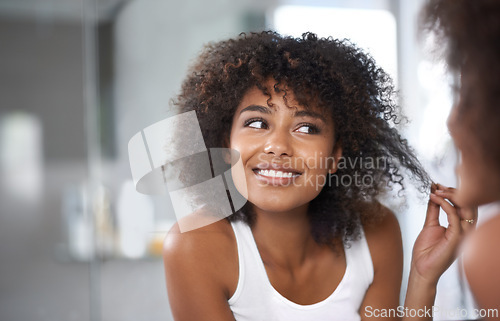 Image of Black woman, mirror and hair with beauty and texture, curly hairstyle or frizz with morning routine in bathroom. Natural, haircare and treatment for growth, shine and cosmetics in reflection at home