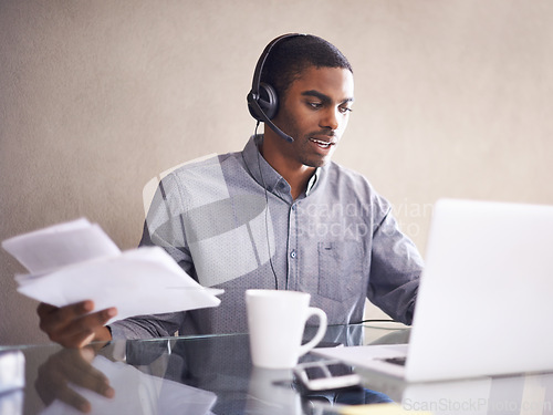 Image of Businessman, laptop and headphones with paperwork for consulting, online advice or call center at office. Black man, consultant or African employee with documents and computer for customer service