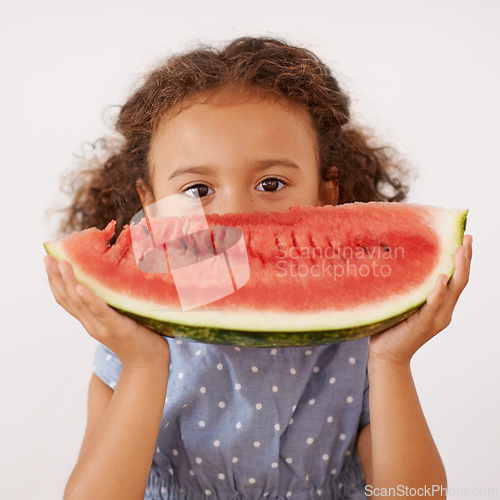 Image of Portrait, eyes or girl with watermelon in studio for healthy, diet or wellness on grey background. Fruit, hiding or kid model face with gut health, nutrition or organic snack for digestion support