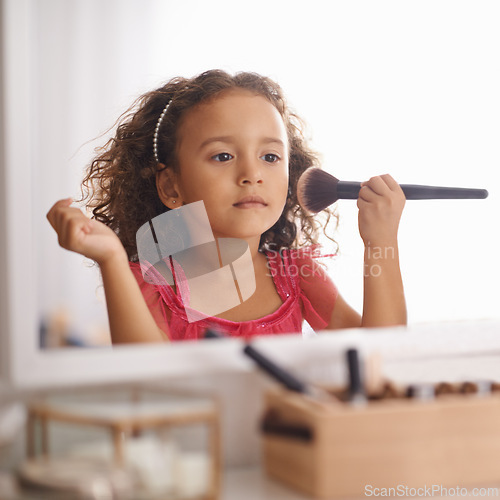 Image of Child, girl and makeup with brush on mirror for role play for creativity and artistic. Kid, female person and bedroom with playing for development, growth and cute for childhood memories and fun.