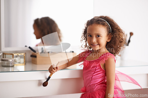 Image of Child, portrait and mirror with makeup for costume, ballet or performance with cosmetics or brush. Girl, smile and reflection of a happy kid in with a princess dress or outfit in the home or house