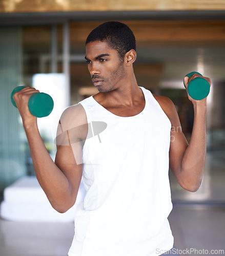 Image of Black man, dumbbell and workout with exercise for bodybuilding, training and fitness. African person, lifting weights and idea or vision with equipment for endurance, wellness and muscle strength