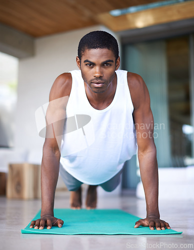 Image of Fitness, portrait and black man do yoga on floor for wellness, flexibility and balance for healthy body. Training, pilates and person on sports mat for stretching, workout and exercise in living room