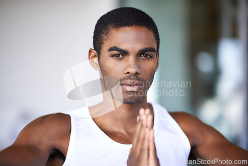 Image of Black man, portrait and praying hands with faith for religion, hope and grateful mindset at home. African person, serious face and peace with spiritual gesture for mindfulness, worship and praise