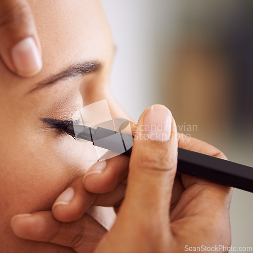 Image of Woman, makeup and eyeliner with eye pencil for beauty, cosmetics or art at salon or spa. Closeup of female person or stylist applying shadow, contour or color product for facial treatment or glamour