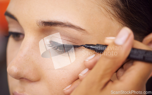 Image of Woman, makeup and eyeliner with mascara for beauty, cosmetics or art at salon or spa. Closeup of female person or stylist applying pencil shadow, contour or color for facial eye treatment or glamour