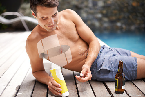 Image of Body, care and man with sunscreen application at a poolside for swimming, fun or sunbathing with beer. Skincare, protection and male person with spf product, cream or lotion for skin safety on a deck