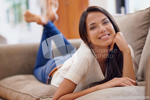 Image of Woman, portrait and smile on sofa for relax weekend or comfortable day off for holiday break, vacation or peace. Female person, face and resting on couch in Mexico apartment, lounge or stress relief