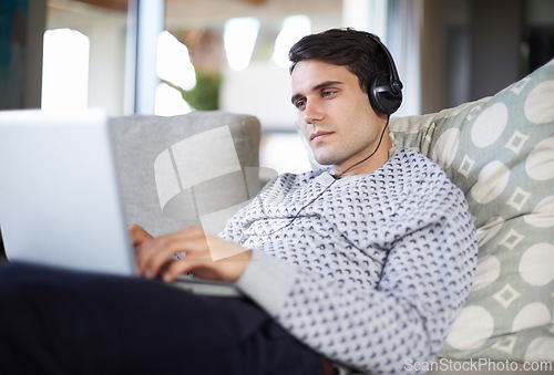 Image of Research, headphones or man on laptop for streaming movies, music or film series in home to relax. Podcast, radio or person on sofa listening online on technology for digital blog or playlist on web