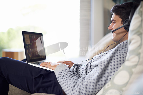 Image of Man, call center or remote work with laptop for customer service, typing or consulting online. Home, virtual assistant or headset on a happy freelance employee with smile for communication or support