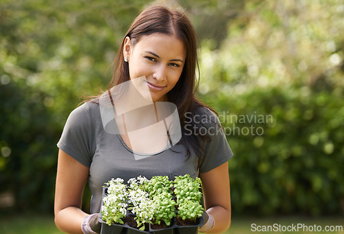 Image of Woman, flowers and gardening with portrait in nature, ecology and sustainability with environment. Landscaping, gardener with plant and eco friendly for growth, greenery and botanical outdoor