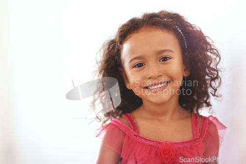 Image of Girl, child and portrait or happiness in home with confidence, wellness and headband for fashion aesthetic. Kid, face and smile with relax on mockup in living room with pride, good mood or curly hair