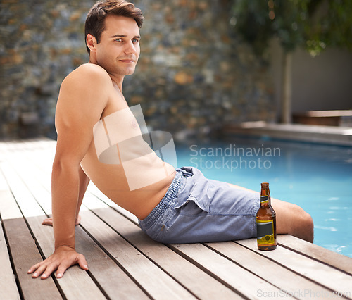 Image of Man, relax and thoughts by swimming pool at resort with beer to drink or chill on summer vacation, luxury and villa. Male person, bottle and alcohol for refreshments on tropical holiday in Maldives.