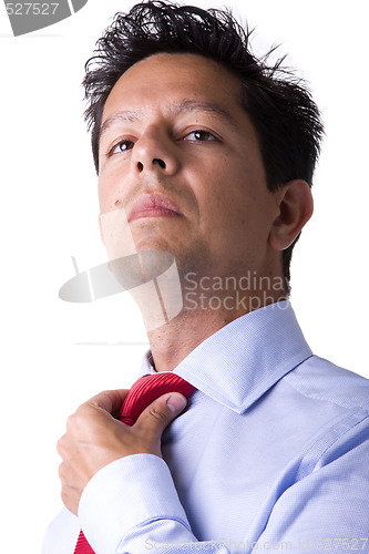 Image of businessman adjusting his necktie 