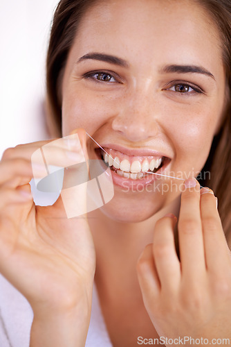 Image of Smile, wellness and portrait of woman with floss for health, dental and clean routine for hygiene. Oral care, happy and female person with dentistry tool for teeth or mouth treatment in bathroom.