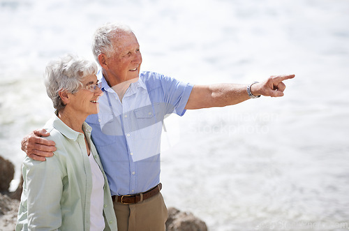 Image of Senior, couple and point at beach with smile for retirement vacation or anniversary to relax with love, view and commitment with support. Elderly man, woman and together by ocean for peace on holiday