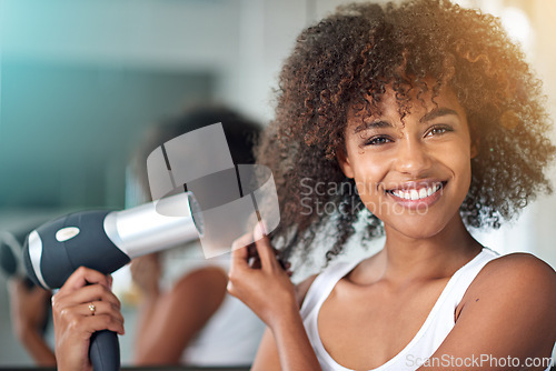 Image of Black woman, hairdryer and hair with texture in portrait, curly hairstyle or frizz for morning routine in bathroom. Natural beauty, haircare and heat treatment for growth, shine and cosmetics at home