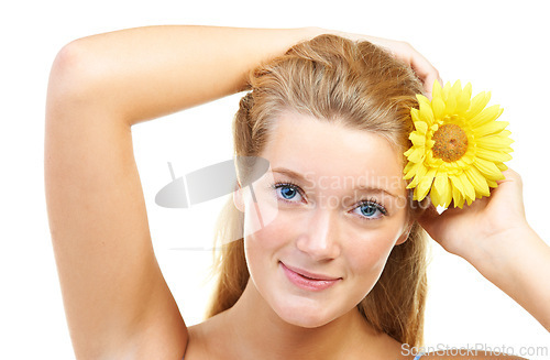 Image of Skincare, portrait and happy woman in studio with sunflower in her hair for natural cosmetics on white background, Flower, smile or model face with wellness, glowing skin or organic beauty treatment