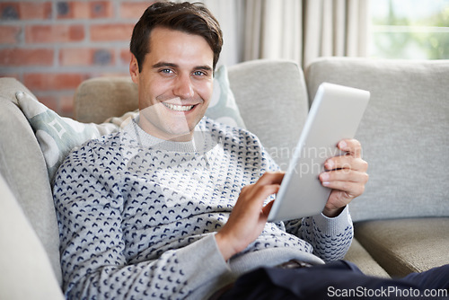 Image of Relax, research or portrait of happy man on tablet for social media blog, post or networking on sofa. Streaming, movie or person online for planning or technology for article, email or news in home