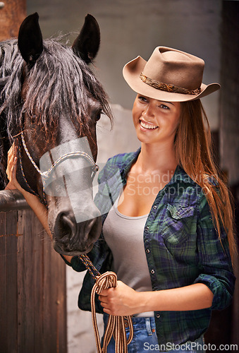 Image of Horse, farm and ranch with young woman in barn or stable for work in agriculture or sustainability. Cowgirl, texas or western and happy animal farmer or owner with stallion for equestrian training