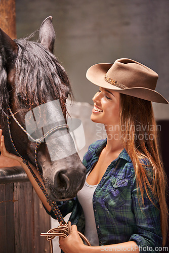 Image of Horse, farm and smile with young woman in barn or stable for work in agriculture or sustainability. Cowgirl, texas or ranch and happy animal farmer or owner with stallion for equestrian training