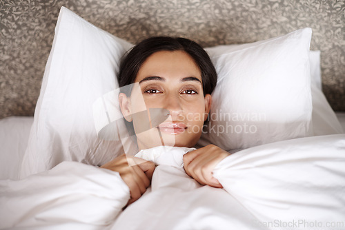 Image of Wake up, portrait and happy woman relax in bed with comfort, blanket or rest in her home from above. Sleep, face and calm female person in bedroom with morning, peace or enjoying a nap in a house