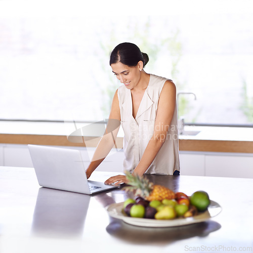 Image of Woman, kitchen and browse website on laptop for recipe ideas or nutritional information for meal planning. Female person, computer and online or search for digital cookbook and food menu for dinner.