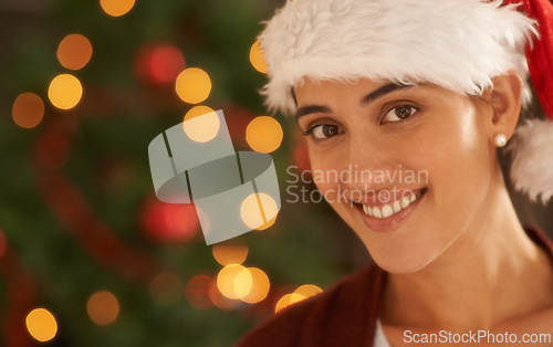 Image of Woman, Christmas tree and portrait with santa hat, happy and pride for festive fashion in home living room. Girl, person and excited for xmas celebration by lights, ornaments or smile in house party