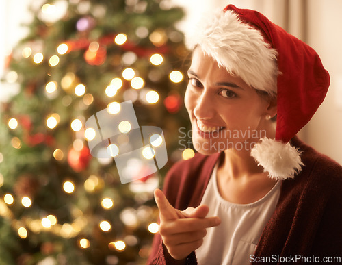 Image of Christmas, portrait or woman for finger, warning or naughty in playful break in festive season. Gen z female person, red hat or smile to hey you, no or humor to relax in living room, tree and lights