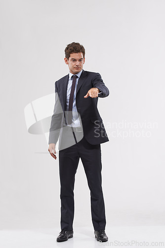 Image of Businessman, studio and pointing with interface for touch, UX or UI on a gray background. Full body of young man, user or employee with interaction for virtual technology, push or click on mockup