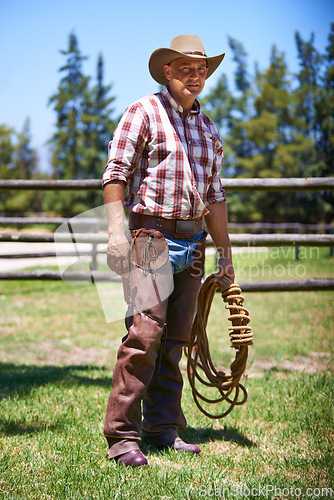 Image of Farm, ranch and portrait of senior cowboy with rope lasso for horse, cows and rodeo animals for agriculture. Farming, nature and mature man in environment, countryside and working outdoors in Texas