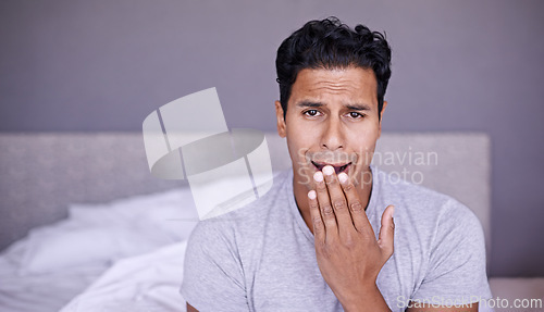 Image of Man, yawn and tired in bedroom in portrait, fatigue and insomnia with sleep problem in morning. Young person, sleepy face or exhausted on break on lazy weekend, pyjamas or stress on bed in apartment