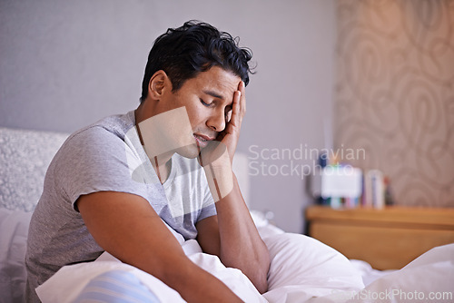 Image of Man, sad and frustrated in bedroom with problem, disappointment and upset with mental health in morning. Young person, unhappy face and headache on weekend with depression and tired on bed in house