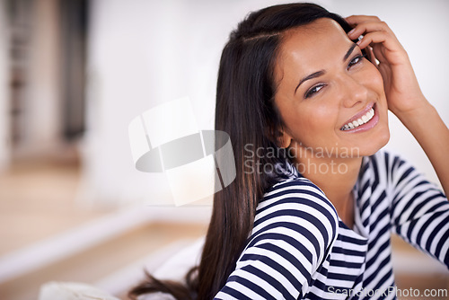 Image of Woman, portrait and smile in home on weekend, couch and satisfaction in living room for enjoyment.. Female person, happy and confident on mockup space, cheerful and wellness by peace or calm mindset