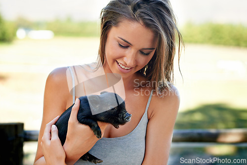 Image of Woman, pig and happiness for wellness, charity organization and rescue center. Volunteer, smile and female person with piglet for foster care, adoption and animal sanctuary for nonprofit or ngo