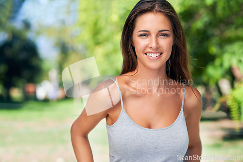 Image of Woman, portrait and smile in summer at park, outdoor fun and holiday in nature and vacation for recreational entertainment. Sunshine, happy and confident fit California female person on break