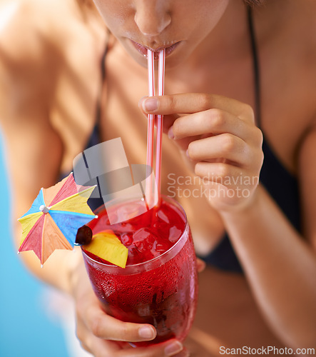 Image of Vacation, hand and woman drinking cocktail in bikini for travel, weekend break and summer party in Fort Lauderdale. Person, glass and alcohol in swimwear for relax, peace and rest at holiday resort