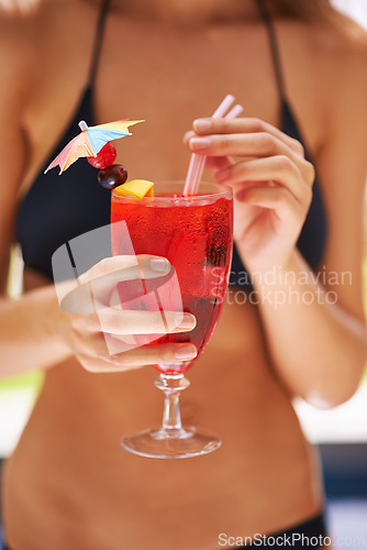 Image of Cocktail, hand and woman in bikini on vacation, weekend break and summer party in Fort Lauderdale. Person, glass and alcoholic drink in swimwear for relax, peace and rest outdoor at holiday resort