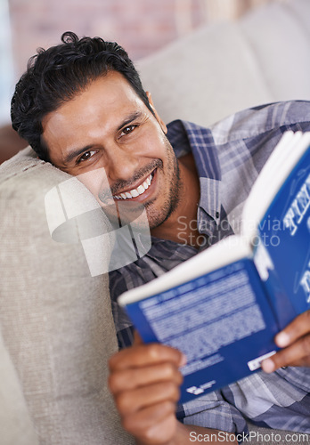 Image of Man, portrait and reading a book for knowledge in home, literature and information. Happy male person, story and fiction novel for education in living room on weekend, comfortable and relax on sofa
