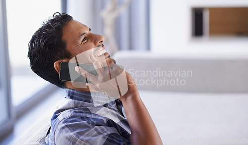 Image of Man, smartphone and laugh on sofa for phone call, funny conversation and communication in living room. Indian person, relax and technology in apartment for discussion, joke and mobile contact